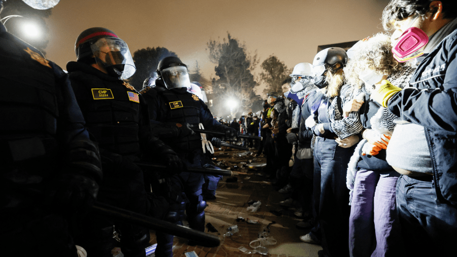 Police face-off with pro-Palestinian students after destroying part of the encampment barricade on the campus of the University of California, Los Angeles (UCLA) in Los Angeles, California, early on May 2, 2024.