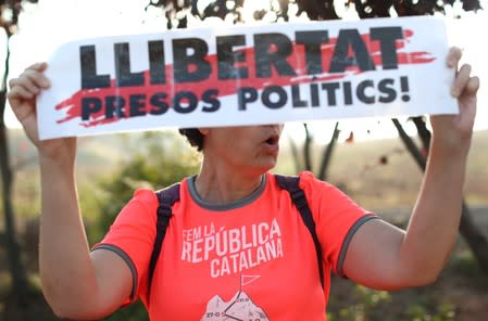 A woman holds a banner as she shouts slogans outside the Lledoners prison in Catalonia where jailed Catalan leaders await a verdict in a trial over a banned independence referendum in Sant Joan de Villatorrada