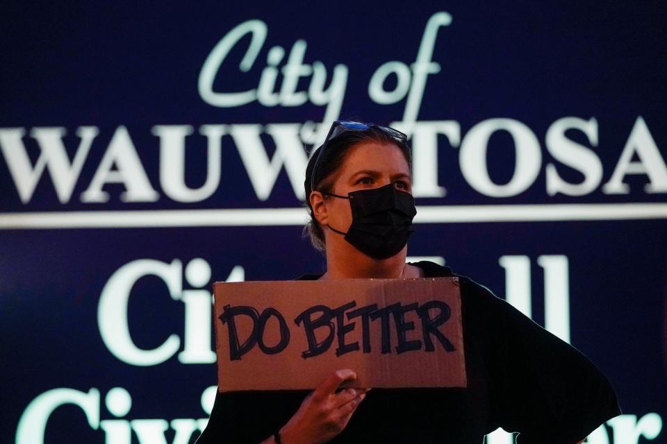 A protester stands in front of the Wauwatosa City Hall Friday, Oct. 9, 2020. Mayfair Mall.