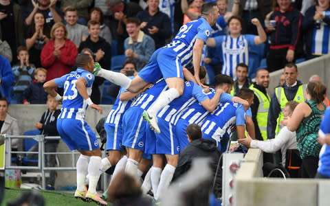 Brighton players celebrate Hemed's goal, which helped the side to their first win of the season  - Credit: Mike Hewitt/Getty Images 