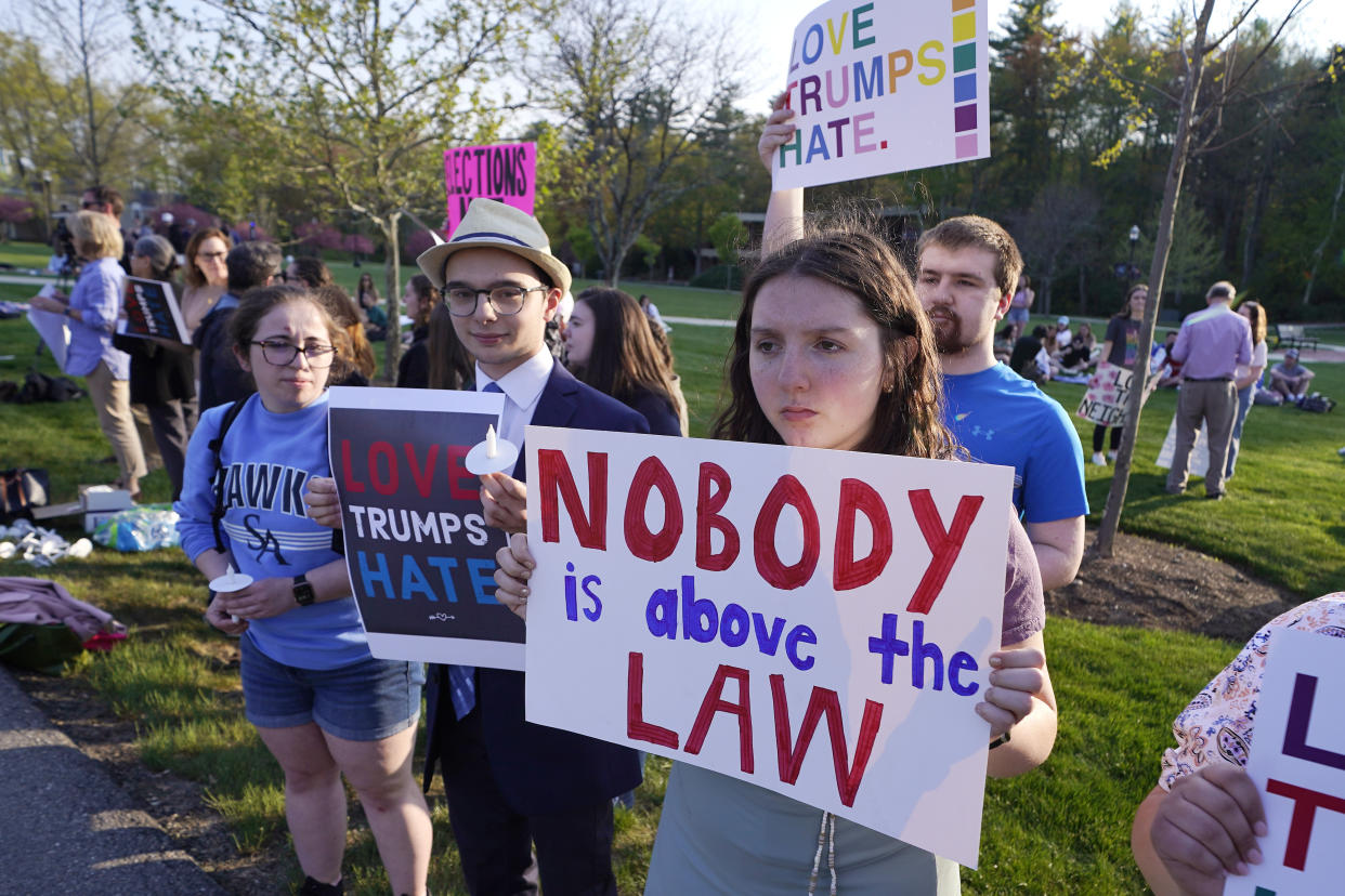 People protest outside a building on the campus of Saint Anselm College where a CNN televised town hall gathering with former President Donald Trump will be held, Wednesday, May 10, 2023, in Manchester, N.H. (AP Photo/Charles Krupa)