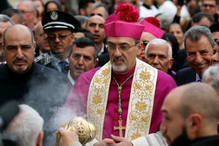 The acting Latin Patriarch of Jerusalem Pierbattista Pizzaballa participates in Christmas celebrations at Manger Square outside the Church of the Nativity in Bethlehem, in the Israeli-occupied West Bank December 24, 2018. REUTERS/Mussa Qawasma