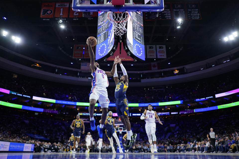 Philadelphia 76ers' Tyrese Maxey, left, goes up for a shot against Indiana Pacers' Bennedict Mathurin during the first half of an NBA basketball game, Sunday, Nov. 12, 2023, in Philadelphia. (AP Photo/Matt Slocum)