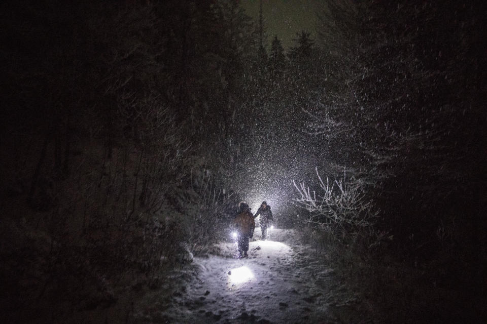 A group of Syrian refugees walk their way under a blizzard as they attempt to enter the EU through Croatia in the mountains surrounding the town of Bihac, northwestern Bosnia on Dec. 12, 2019. (Photo: Manu Brabo/AP)
