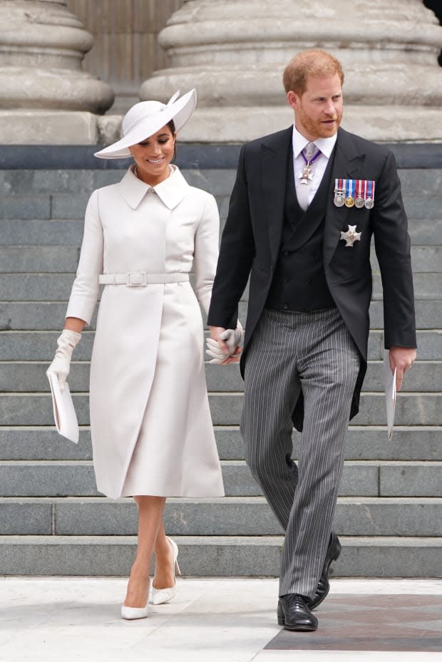 <p>For their first joint trip back across the pond since stepping down as senior royals, Meghan Markle went back to neutrals. She wore a crisp custom pale stone-colored Dior coat dress with matching gloves, heels, hat and bag.</p><p>Kirsty O'Connor - WPA Pool/Getty Images</p>