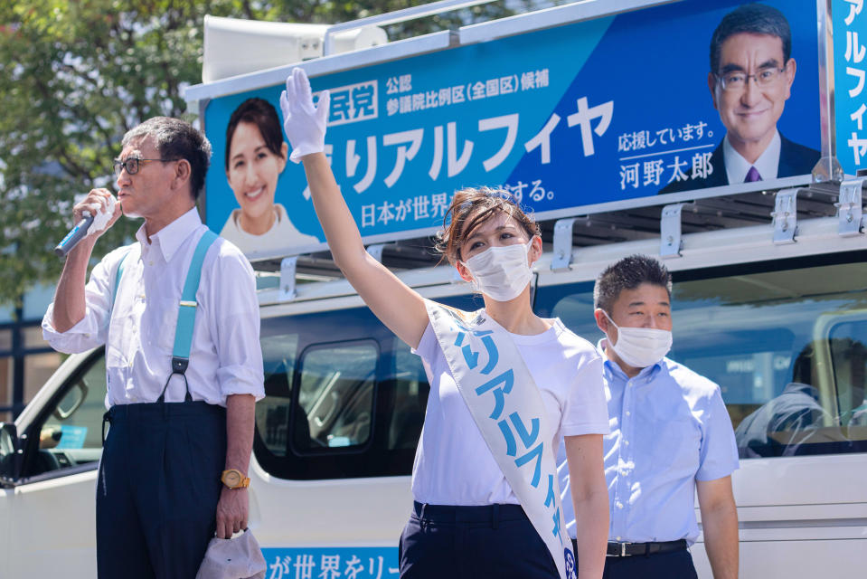 Arfiya, the LDP candidate for the upper house election of 2022, waves her hand at a crowd while Taro Kono, then director of the Liberal Democratic Party public affairs department, gives a speech in her support during a campaign rally in Yokohama, Japan, on June 26, 2022.<span class="copyright">Stanislav Kogiku—AFLO/Shutterstock</span>