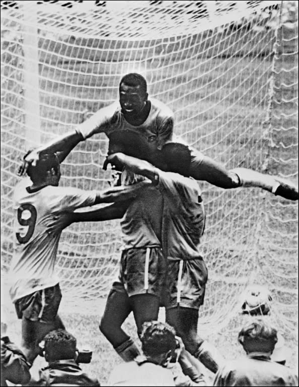 Pele (top) celebrates with his teammates (from L) Tostao, Carlos Alberto and Jairzinho during the World Cup final between Brazil and Italy on June 21, 1970 in Mexico City