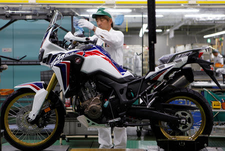 FILE PHOTO - A worker is seen at an assembly line of Honda Motor Co.'s motorcycles at Honda's Kumamoto factory in Ozu town, Kumamoto prefecture, Japan, September 13, 2016. REUTERS/Naomi Tajitsu/File Photo