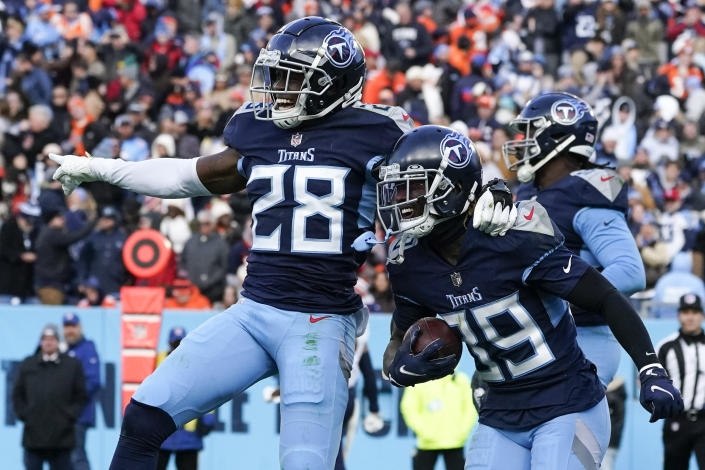 Tennessee Titans cornerback Terrance Mitchell and Tennessee Titans safety Joshua Kalu (28) celebrate the interception made by Mitchell during the second half of an NFL football game against the Denver Broncos, Sunday, Nov. 13, 2022, in Nashville, Tenn. The Tennessee Titans won 17-10. (AP Photo/Mark Humphrey)