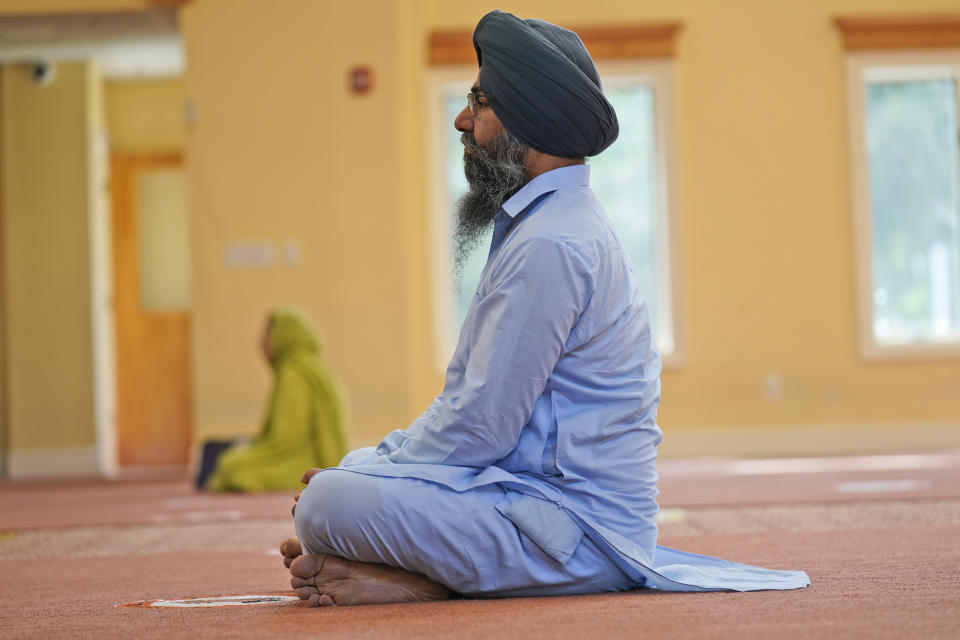 Raghuvinder Singh participates in a Sikh worship service at a gurdwara in Glen Rock, N.J., Sunday, Aug. 15, 2021. Baba Punjab Singh, a Sikh priest visiting from India, was shot in the head by a white supremacist Army veteran in Wisconsin in 2012, and left partially paralyzed. He died from his wounds in 2020. Over seven years, the priest’s son, Raghuvinder Singh, split his time between caring for his father in Oak Creek and working in Glen Rock, New Jersey, as assistant priest at a gurdwara there. Raghuvinder said the greatest lesson his father taught him was how to embody “chardi kala,” which calls for steadfast optimism in the face of oppression. (AP Photo/Seth Wenig)