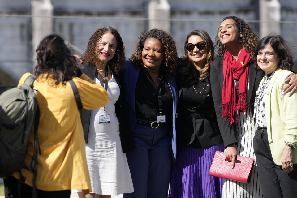 Brazilian government ministers pose for an informal group photo with the 16th century Jeronimos monastery in the background, during the Portugal-Brazil summit at the Belem Cultural Center in Lisbon, Saturday, April 22, 2023. They are, from right, Health Minister Nisia Trindade, Minister of Racial Equality Anielle Franco, Brazilian first lady Rosangela da Silva, Culture Minister Margareth Menezes and Science and Technology Minister Luciana Santos. (AP Photo/Armando Franca)