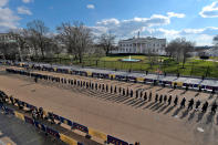 <p>An honor guard lines up outside the White House, surrounded by Biden-Harris banners. </p>