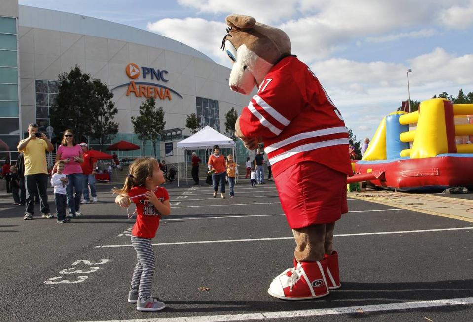 Charlotte Cavallaro, 2, from Raleigh dances with Stormy outside the arena as the Carolina Hurricanes hold the Caniac Carnival before a preseason scrimmage at the PNC Arena in Raleigh, N.C. on Sept. 26, 2014.