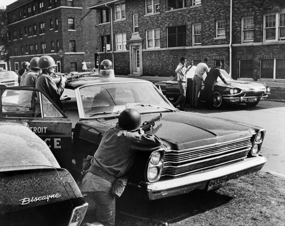 Police arrest suspects during riots that erupted in Detroit in July 1967. <a href="https://www.gettyimages.com/detail/news-photo/policemen-arrest-suspects-in-a-detroit-street-on-july-25-news-photo/460590236?adppopup=true" rel="nofollow noopener" target="_blank" data-ylk="slk:AFP via Getty Images;elm:context_link;itc:0;sec:content-canvas" class="link ">AFP via Getty Images</a>