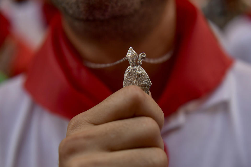 <p>A man pays his respects to Saint Fermin, ahead of the first running of the bulls at the San Fermin Festival, in Pamplona, northern Spain, Friday, July 7, 2017. (Alvaro Barrientos/AP) </p>