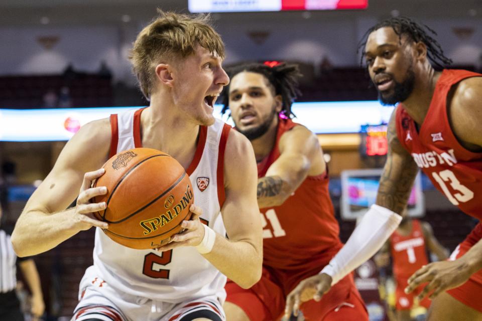 Utah’s Cole Bajema (2) looks to pass the ball against the defense of Houston’s Emanuel Sharp (21) and J’Wan Roberts (13) in the first half of an NCAA college basketball game during the Charleston Classic in Charleston, S.C., Friday, Nov. 17, 2023. | Mic Smith, Associated Press