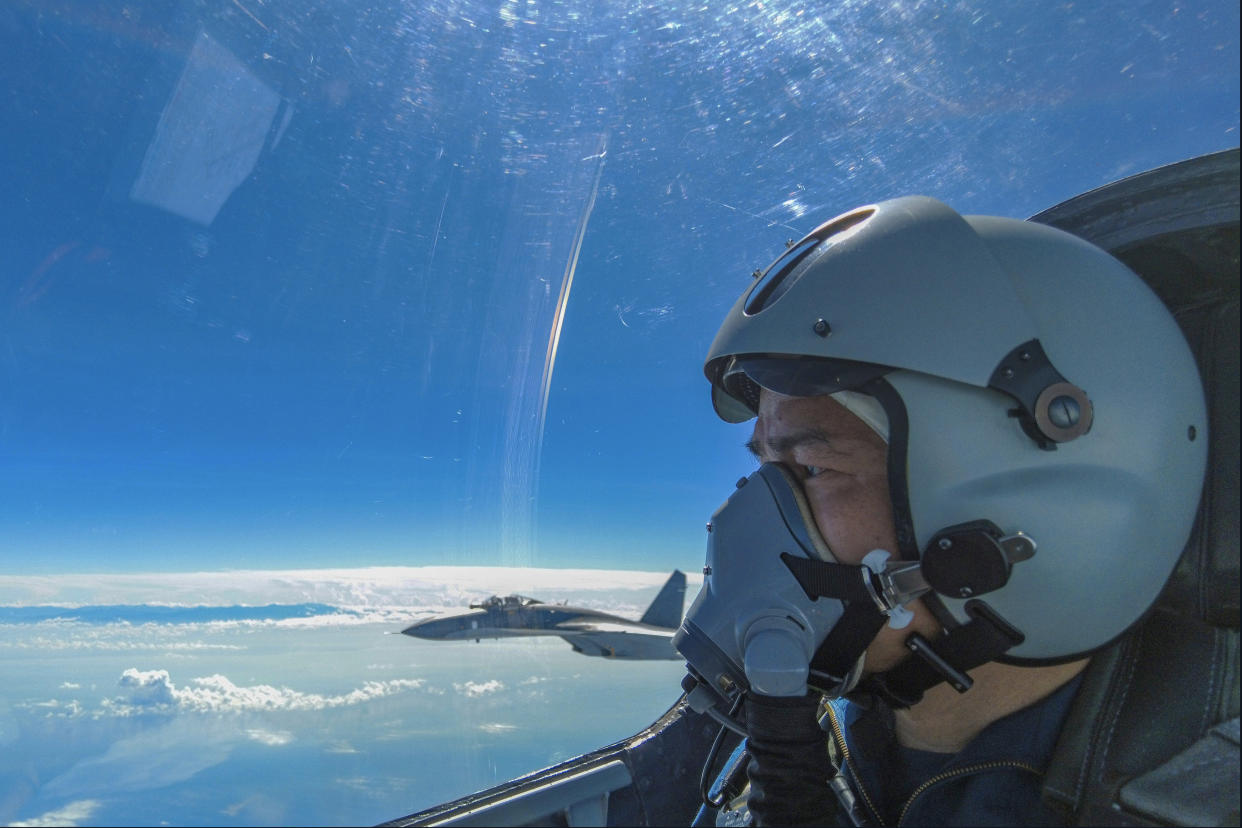 An air force pilot from the Eastern Theater Command of the Chinese People's Liberation Army looks as they conduct a joint combat training exercises around the Taiwan Island on Sunday, Aug. 7, 2022. (Wang Xinchao/Xinhua via AP)