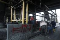 Workers clean up the burnt Lekki toll gate in Lagos