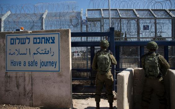 Israeli soldiers stand guard at the Quneitra crossing in the Golan Heights (EPA)