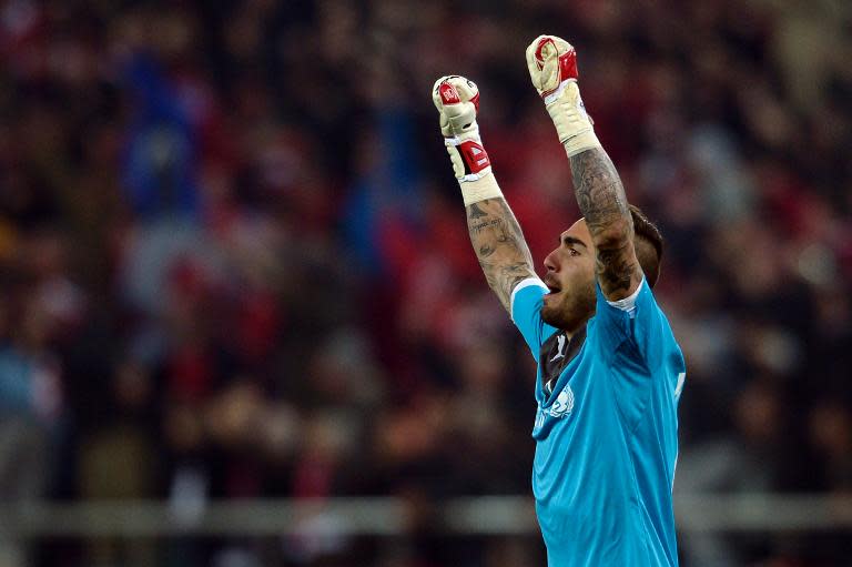 Olympiakos' Spanish goalkeeper Roberto celebrates after his team scored a goal during the round of 16 Champions League football match Olympiakos vs Manchester United at Karaiskaki Stadium in Athens on February 25, 2014