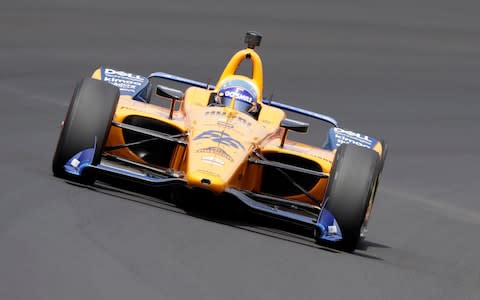 Fernando Alonso, of Spain, drives through turn one during practice for the Indianapolis 500 IndyCar auto race at Indianapolis Motor Speedway - Credit: AP