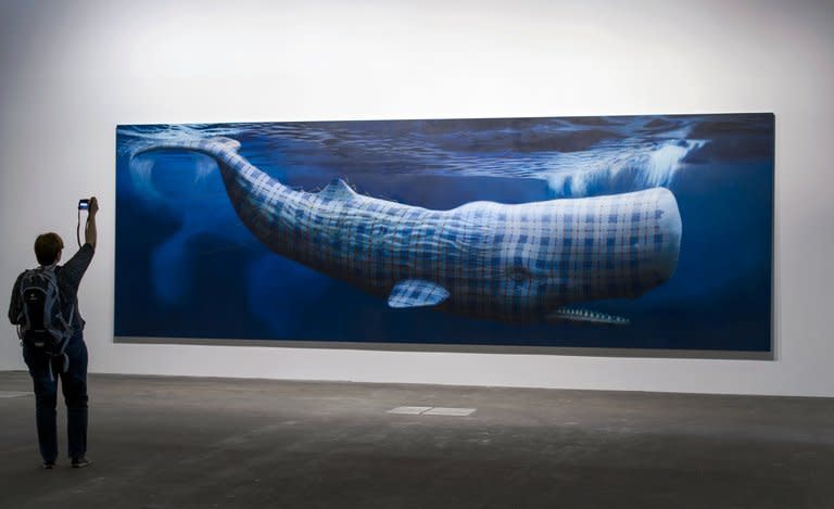 A visitor snaps a picture of Sean Landers' "Moby Dick (Merrilees)" during an Art Basel preview on June 10, 2013. The 44th edition of Art Basel opens to the public on Thursday, but the doors were nudged open on Tuesday for special VIPs wanting an advance peek