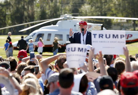 Republican presidential candidate Donald Trump speaks after arriving in his helicopter as a group of children race towards it for ride during a rally in Sarasota, Florida November 28, 2015. REUTERS/Scott Audette