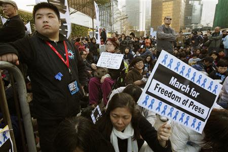 Protesters sit outside the office of Hong Kong's Chief Executive during a demonstration demanding for freedom of speech and press freedom in Hong Kong February 23, 2014. REUTERS/Bobby Yip