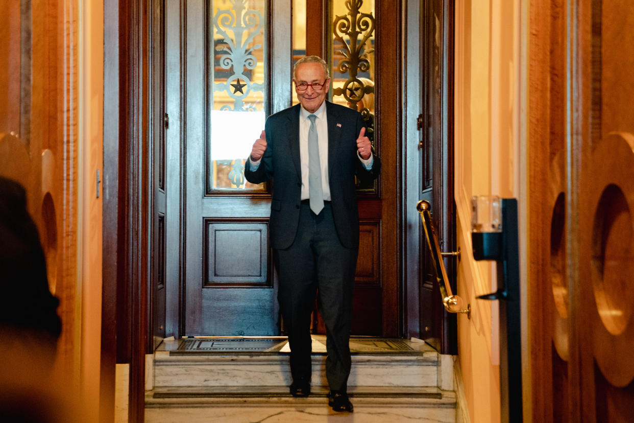 Senate Majority Leader Chuck Schumer gives a thumbs-up as he leaves the Senate chamber.