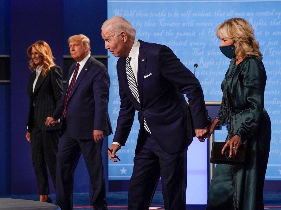 President Donald Trump holds hands with First Lady Melania Trump and Joe Biden and Jill Biden are doing the same on the debate stage in Cleveland in September 2020.