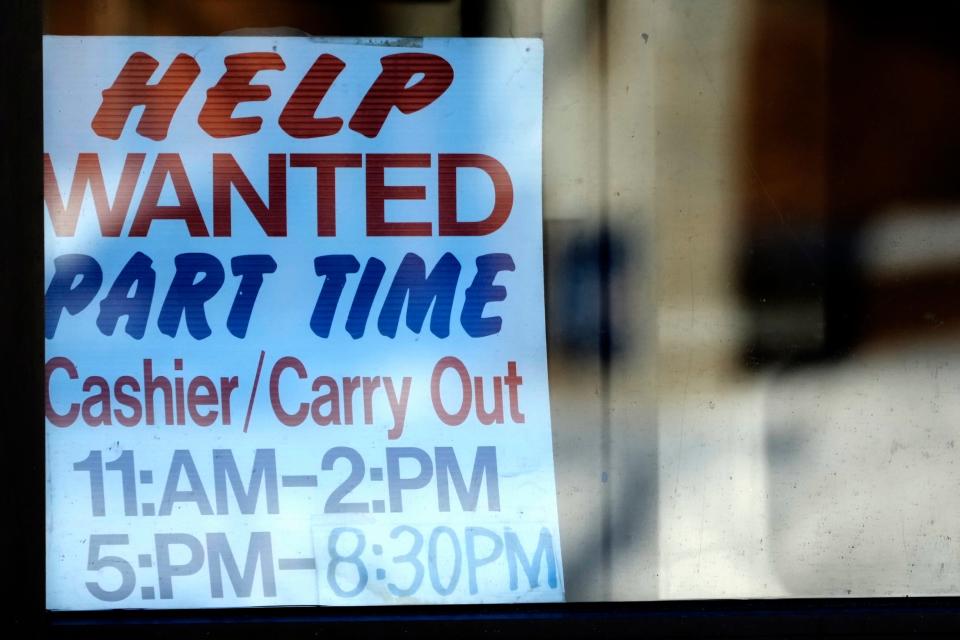 A help wanted sign is displayed at a restaurant in Arlington Heights, Ill.