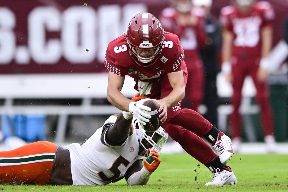 Temple quarterback E.J. Warner (3) is tackled for a loss by Miami defensive lineman Leonard Taylor III during the first half of an NCAA college football game, Saturday, Sept. 23, 2023, in Philadelphia. (AP Photo/Derik Hamilton)