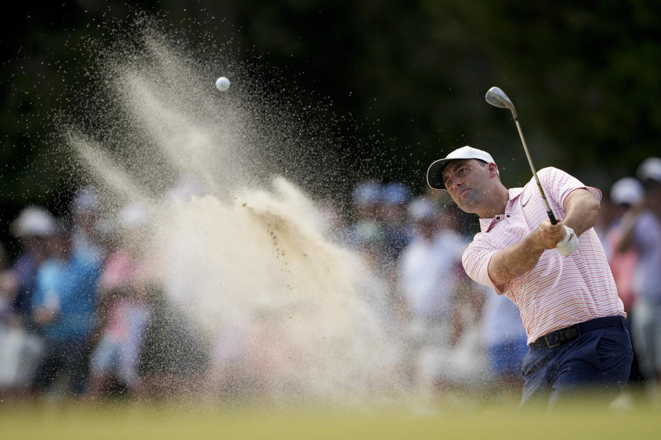 Scottie Scheffler hits from the bunker on the 12th hole during the first round of the U.S. Open golf tournament Thursday, June 13, 2024, in Pinehurst, N.C. (AP Photo/Matt York)