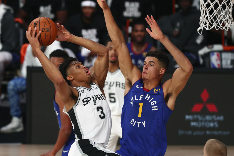 San Antonio Spurs forward Keldon Johnson (3) shoots against Denver Nuggets forward Michael Porter Jr. (1) during the second half of an NBA basketball game Wednesday, Aug. 5, 2020, in Lake Buena Vista, Fla. (Kim Klement/Pool Photo via AP)