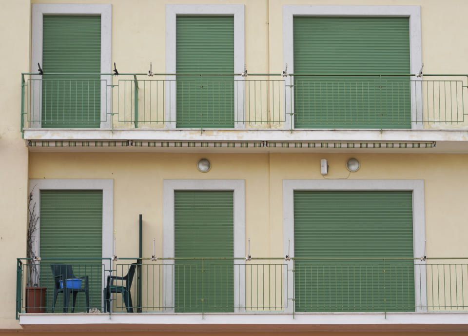 In this picture taken on Tuesday, April 28, 2020, room blinds are lowered at a closed hotel, in Sperlonga, a fashionable seaside town about 120km (80 miles) south of Rome. Normally, at this time of year Sperlonga would already be bustling with its first clients of the season. (AP Photo/Andrew Medichini)