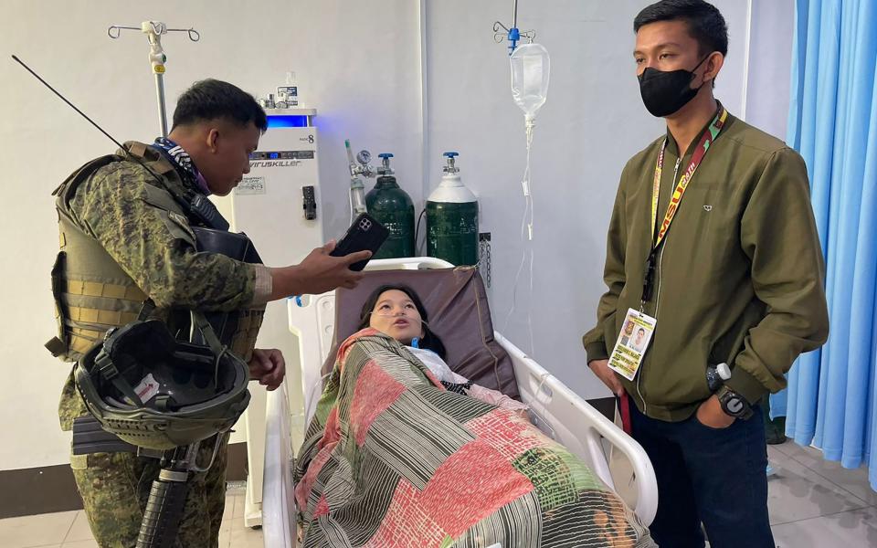 A soldier talks to one of the injured people being treated at Amai Pakpak Medical Center in Marawi, after the attack