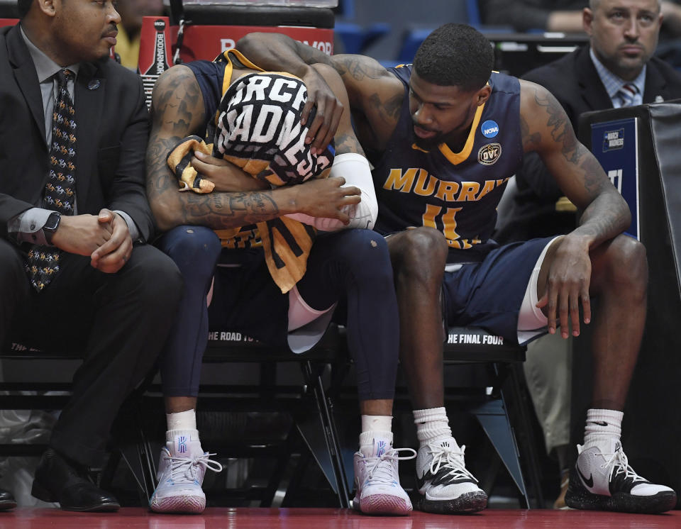 Murray State's Ja Morant, left is consoled by teammate Murray State's Shaq Buchanan, right, during the second half of a second round men's college basketball game against Florida State in the NCAA tournament, Saturday, March 23, 2019, in Hartford, Conn. (AP Photo/Jessica Hill)