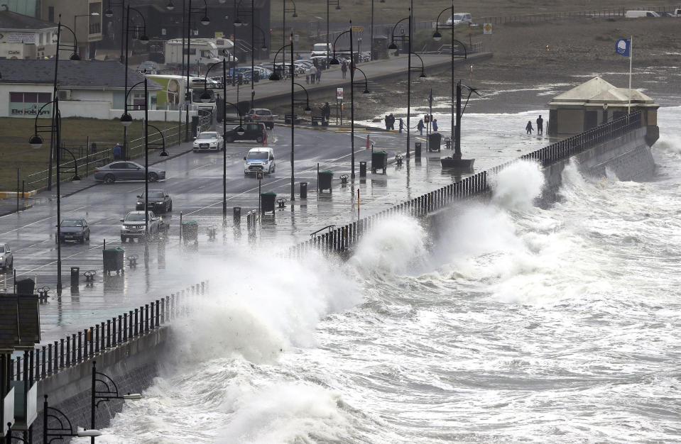 Waves crash into the seafront at Tramore in County Waterford, on the southeast coast of Ireland, Tuesday, Aug. 25, 2020. Storm Francis has brought gusts of more than 50mph overnight ahead of the wet and windy weather impacting vast swathes of the UK and Ireland on Tuesday. (Niall Carson/PA via AP)