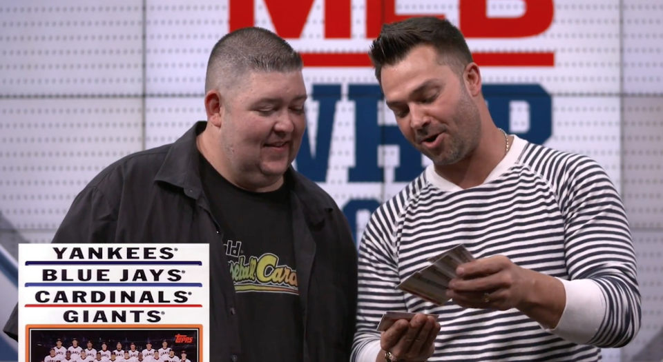 Former MLB star and current Fox Sports analyst Nick Swisher opens baseball cards from 1982 and 2004. (Yahoo Sports)