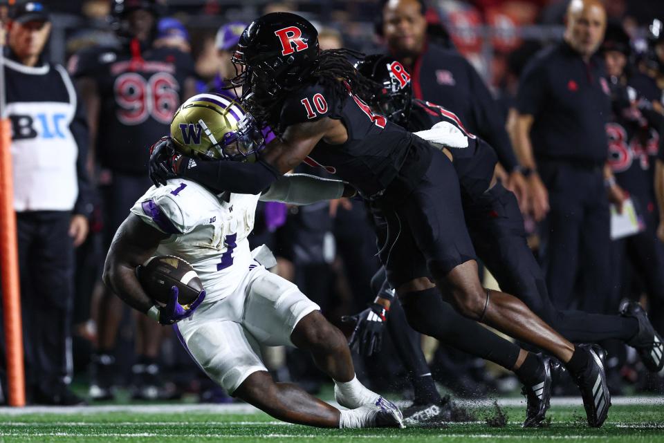 Sep 27, 2024; Piscataway, New Jersey, USA; Washington Huskies running back Jonah Coleman (1) is tackled by Rutgers Scarlet Knights defensive back Flip Dixon (10) during the first half at SHI Stadium. Mandatory Credit: Vincent Carchietta-Imagn Images