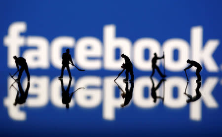 Figurines are seen in front of the Facebook logo in this illustration taken March 20, 2018. REUTERS/Dado Ruvic