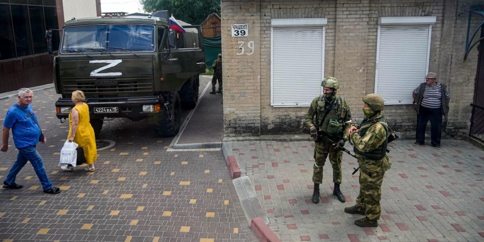 A file photo of Russian soldiers guard an office for Russian citizenship applications as their military truck is parked nearby, in Melitopol, south Ukraine, on July 14, 2022.