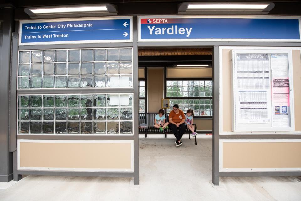 Gina Wieger, of Hamilton, New Jersey, sits with her 9-year-old daughters, Maria, left, and Sophia, right, at the Yardley station waiting to take a southbound train on SEPTA's West Trenton regional rail line to their appointments at the Children's Hospital of Philadelphia in Center City on Monday, June 12, 2023.