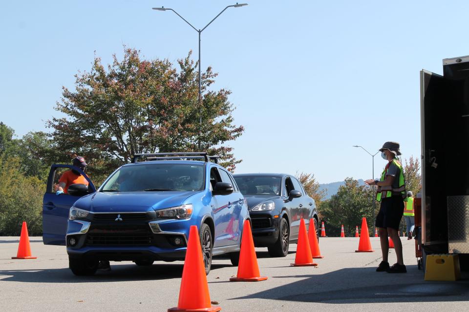 Cars file through the Buncombe County vaccination site at Biltmore Church on Clayton Road in Arden Sept. 28, where officials are administering booster shots of the Pfizer COVID-19 vaccine.