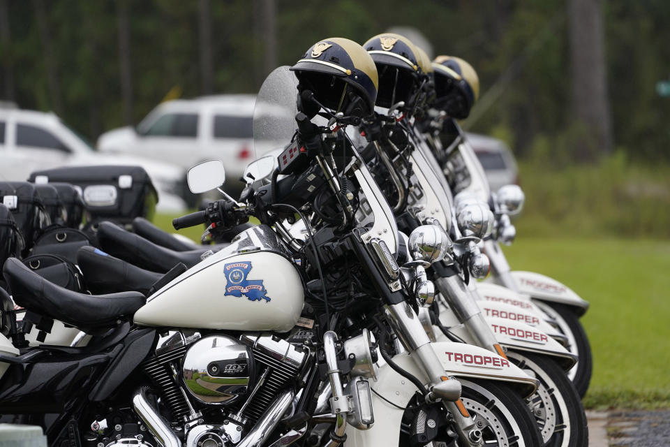 Motorcycles and helmets are ready to escort the hearse carrying the body of Louisiana State Police Master Trooper Chris Hollingsworth, to its burial site in West Monroe, La., Friday, Sept. 25, 2020. Hollingsworth, killed in a car crash hours after he was told he would be fired for his role in the death of a Black man, was buried with honors Friday at a ceremony that authorities sought to keep secret out of concerns it would attract a mass protest. (AP Photo/Rogelio V. Solis)