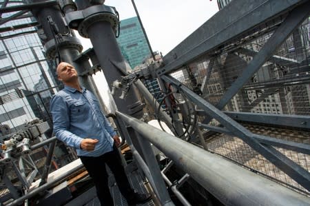 Aerialist Nik Wallenda takes a look on a terrace as he prepares for a highwire walk over Times Square, during his interview in New York