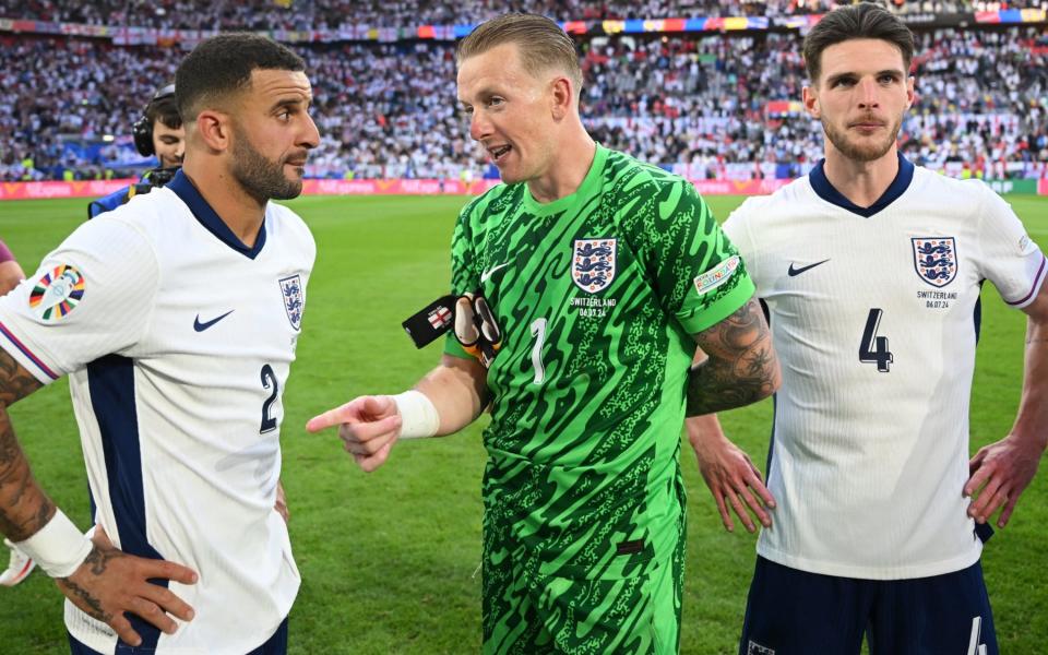 Kyle Walker and Jordan Pickford chat with Declan Rice alongside after their win