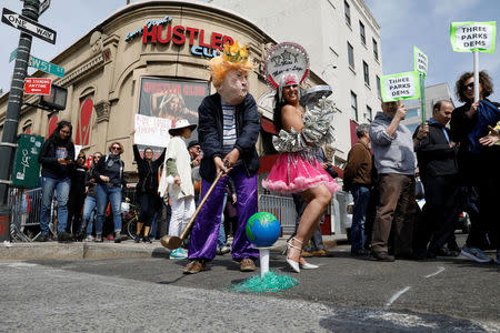 Protesters, including a person impersonating U.S. President Donald Trump, gather ahead of the anticipated arrival of the president in the Manhattan borough of New York, U.S. May 4, 2017. REUTERS/Brendan McDermid