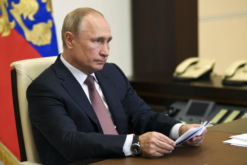 Russian President Vladimir Putin takes part in a video conference on the opening of medical facilities for COVID-19 patients built by the military across the country in the Novo-Ogaryovo residence outside Moscow, Russia, Friday, May 15, 2020. The Russian Defense Ministry built 16 hospitals with a total capacity of 1,600 patients.(Alexei Nikolsky, Sputnik, Kremlin Pool Photo via AP)