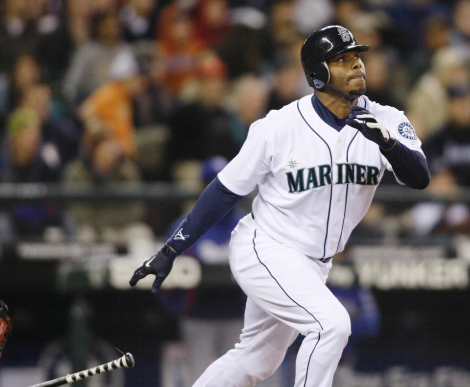 Ken Griffey Jr. drops the bat after hitting the ball